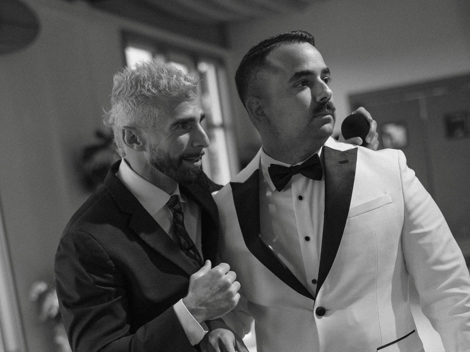 DJ Shazam with a groom at the reception, mid-conversation