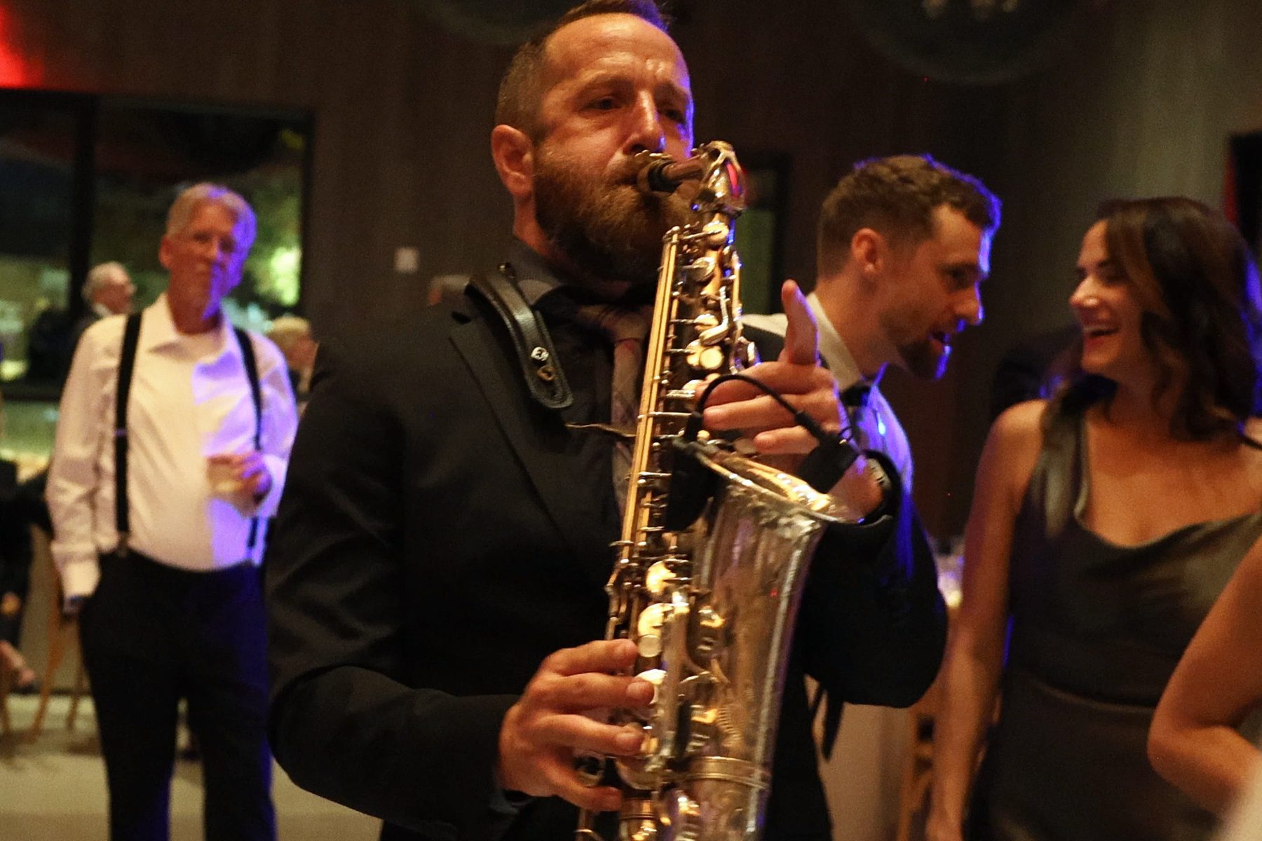 A saxophonist playing among guests on the dance floor at a Healdsburg wedding